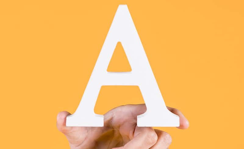 hand holding the letter A