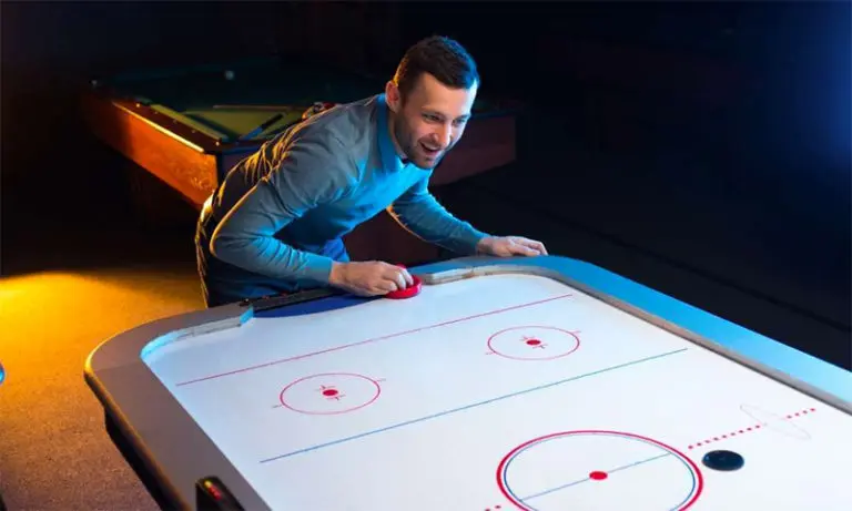 guy playing air hockey