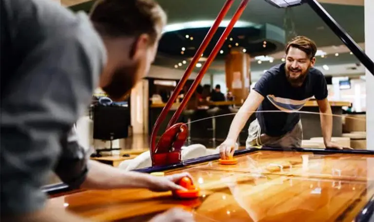 guys playing air hockey