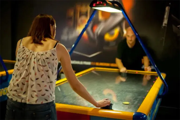 people playing air hockey