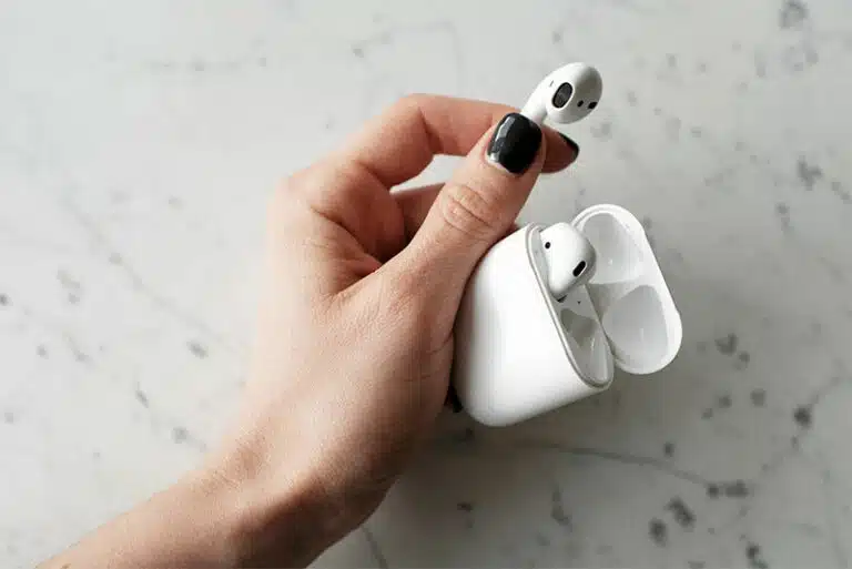 person holding airpods